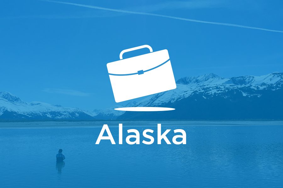 A suitcase and the word Alaska on a blue background.