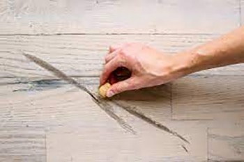 Scuff on hardwood floor is considered tenant-caused damage.