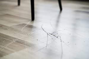 Scratched laminate floor damage.