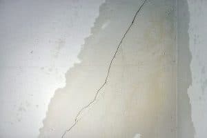 Wall cracks and dripping water.