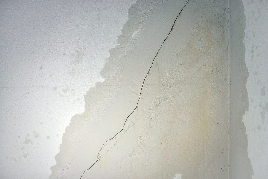 Wall cracks and dripping water.