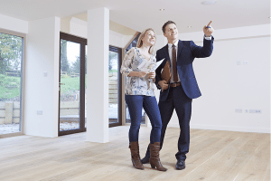 Male realtor with a woman client checking the property.