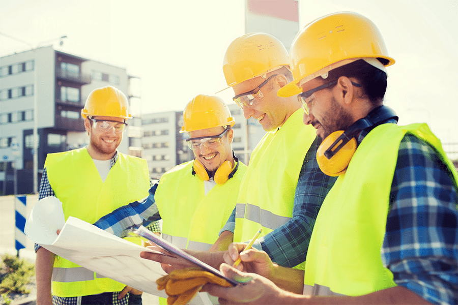 group of people discussing about blueprints