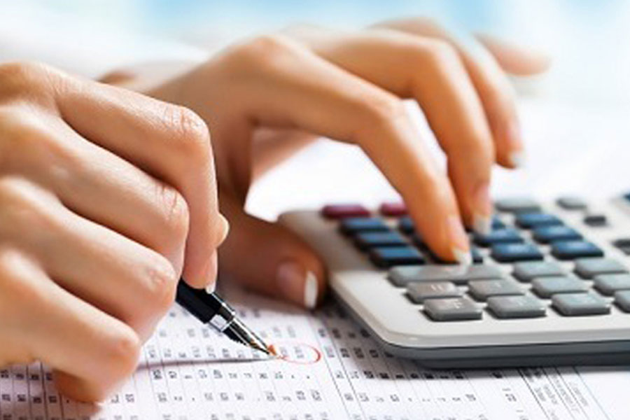 Hand of woman working using calculator