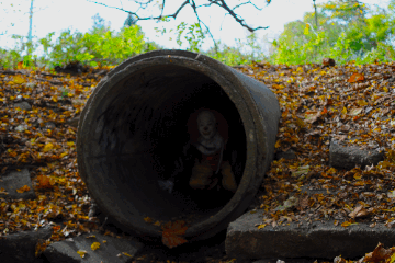 scary clown coming out tunnel gif