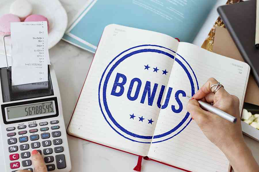 Calculator and the word Bonus written on a notebook.