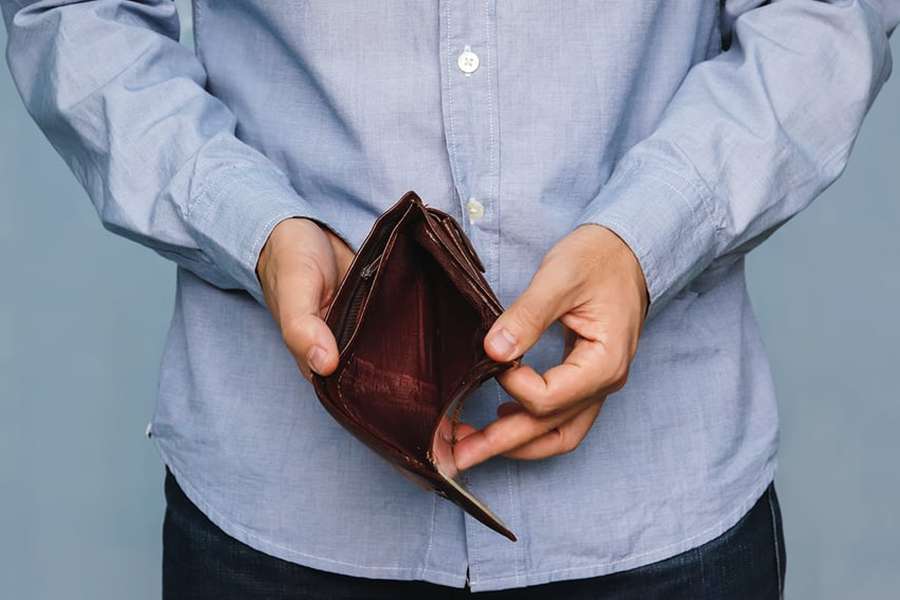 Man holding an empty wallet.
