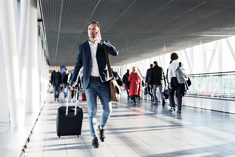 man holding luggage on call