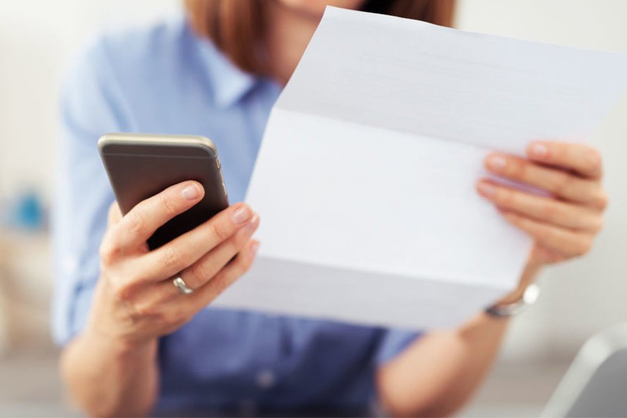 woman holding a phone and script