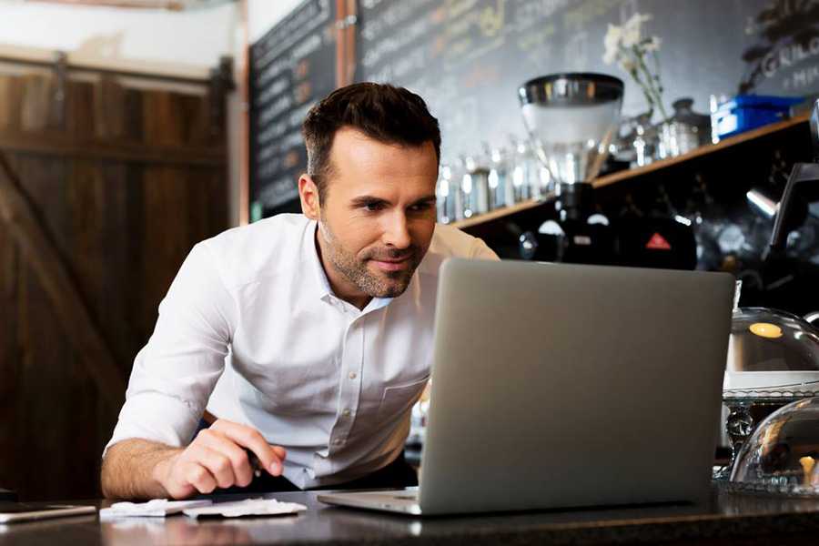 Man enthusiastically working on his laptop