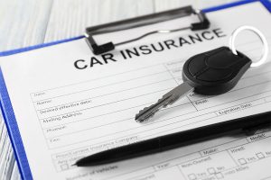 car keys and car insurance sheet