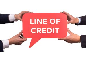 A hand holding a speech bubble with "Line of Credit" written inside.
