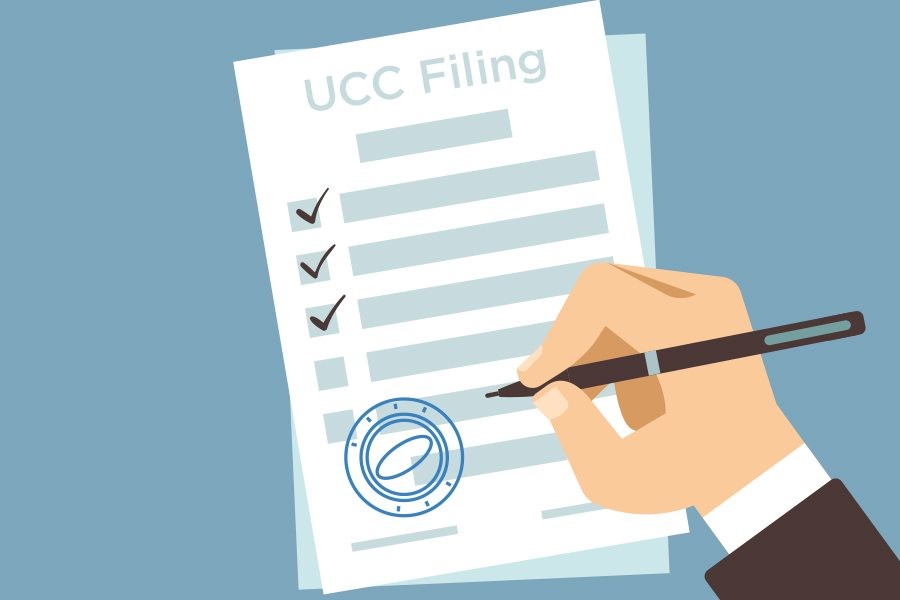 hand checking UCC Filing document