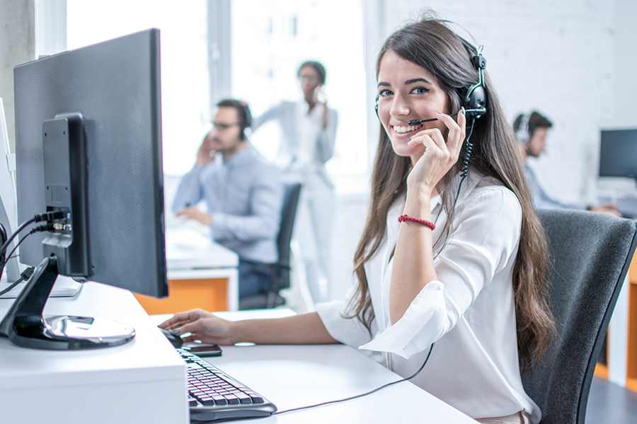 Female call center agent sitting on her working station.