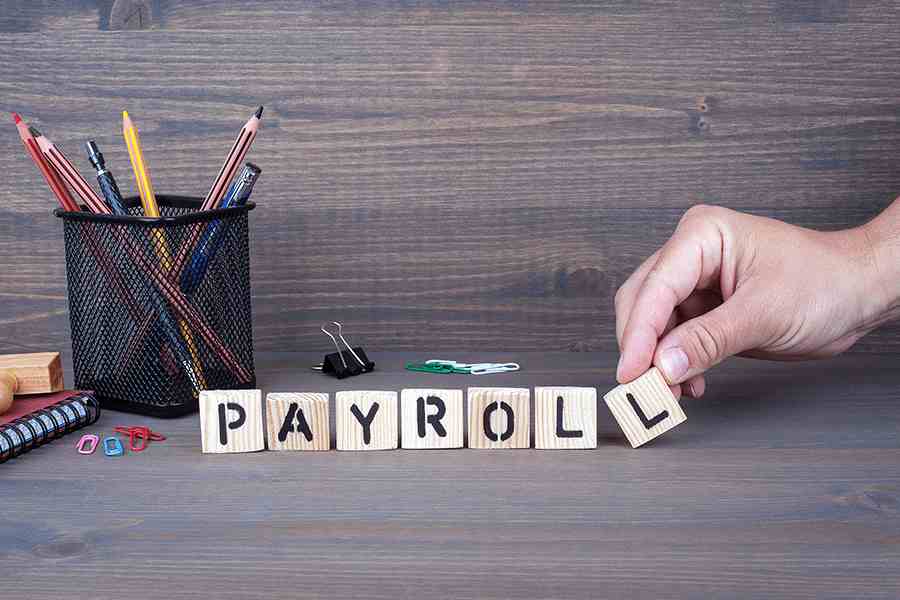 Spelling payroll using letter tiles.