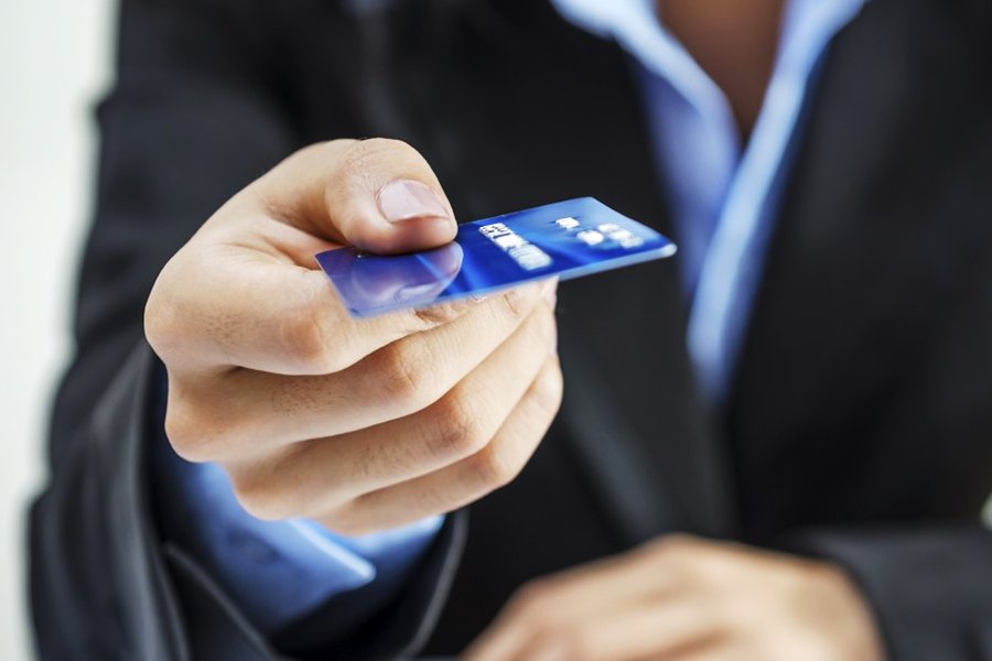 man holding a blue credit card