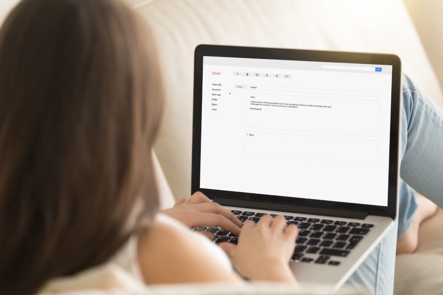 Woman composing email on her laptop.