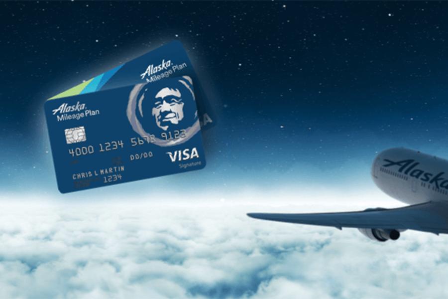 Two Alaska Airlines Visa Business Credit Card and and airplane.