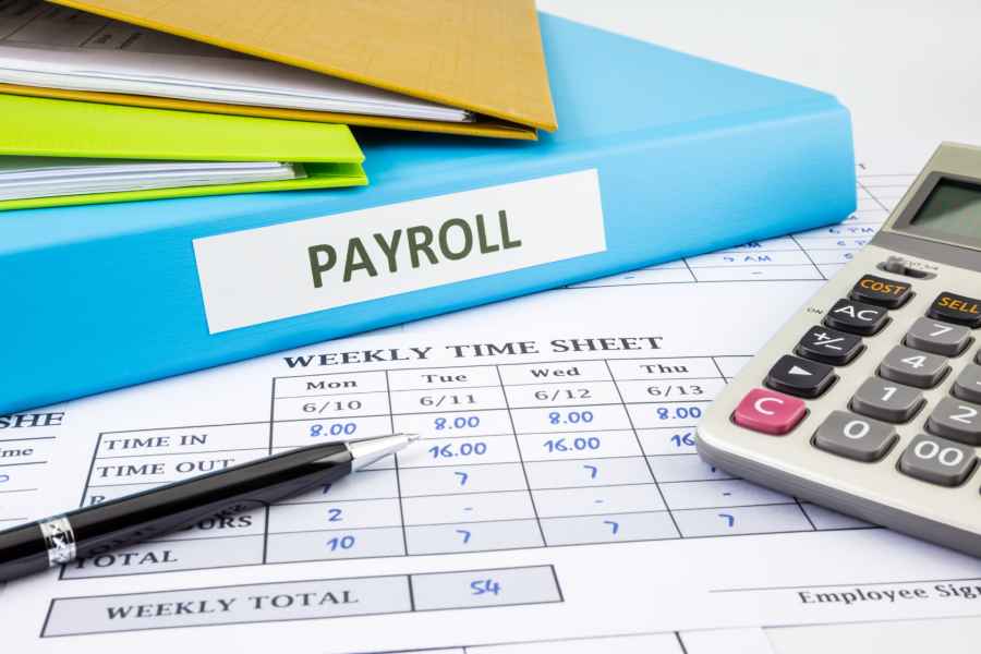 PAYROLL word on blue binder place on weekly time sheet and payroll summary report