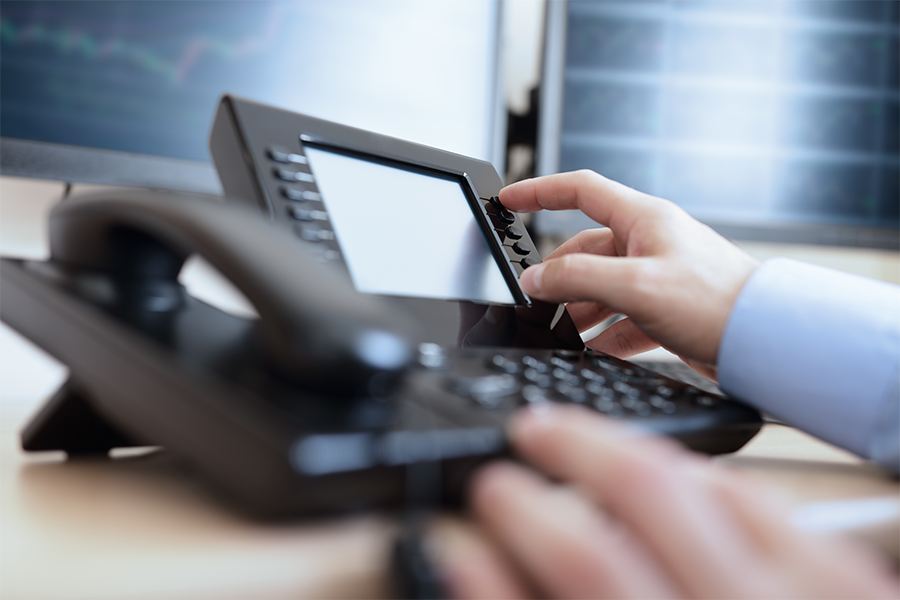 Businessman dialing phone in the office.