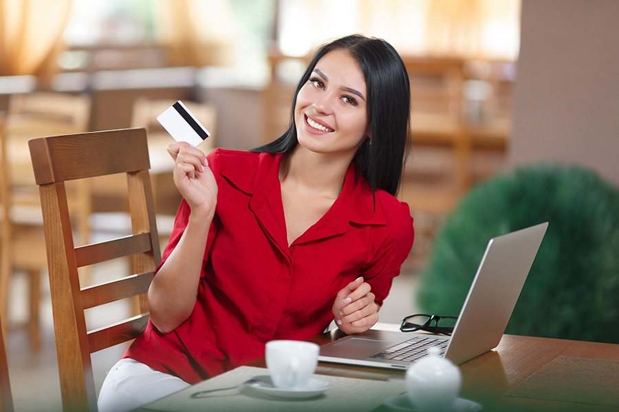 Woman holding a credit card.