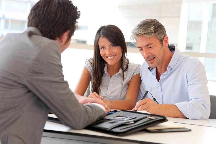 Two couple listening to business agent orientation.