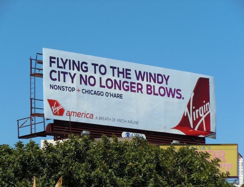 A billboard for Virgin Airlines in Chicago with the copy "Flying to the windy city no longer blows."