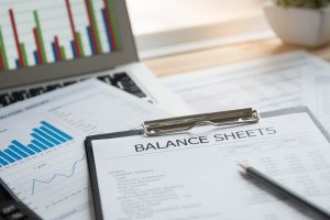 Balance sheet and business reports place on top of a table.