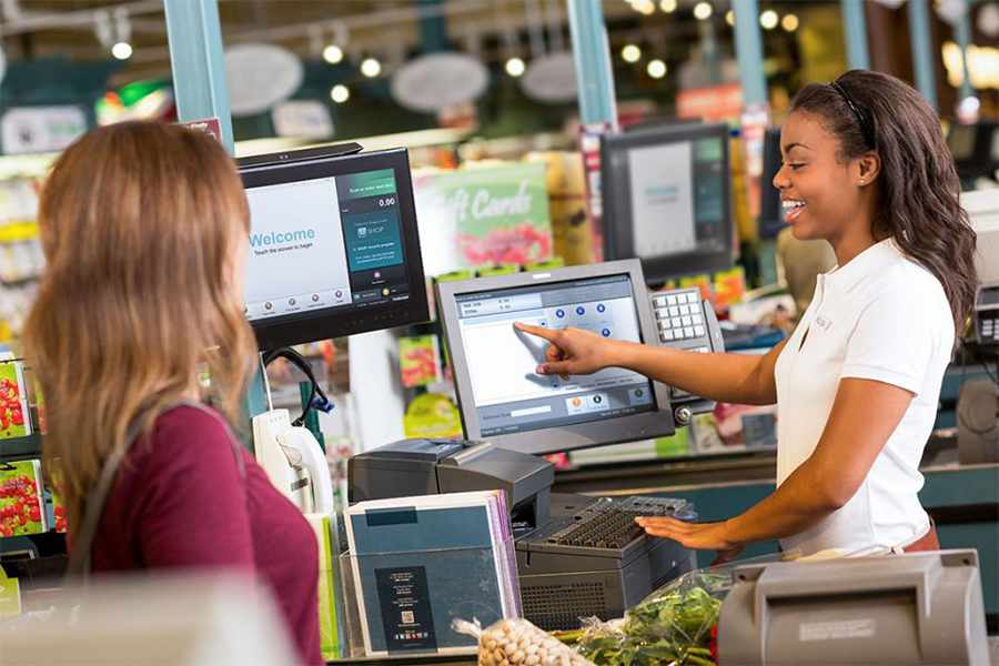 Showing a customer and a cashier staff transacting.