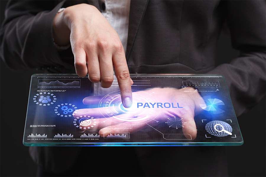 Man pointing on a smart technology with payroll on screen.