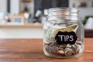 Tip money inside a jar.