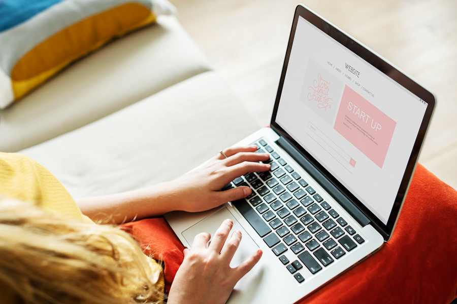 Web developer editing a Squarespace website layout on his laptop.