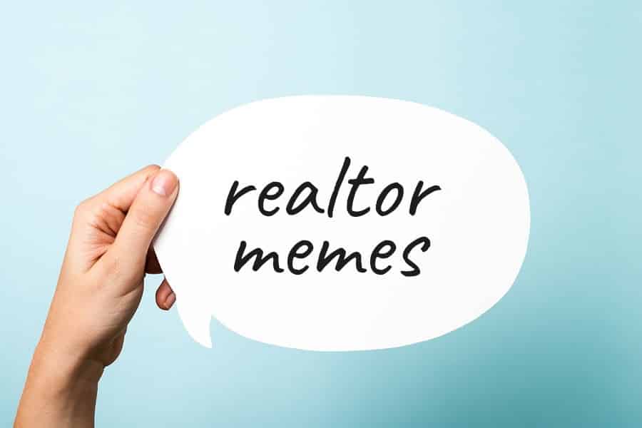 Hand holding a callout card with "realtor memes" written on it.