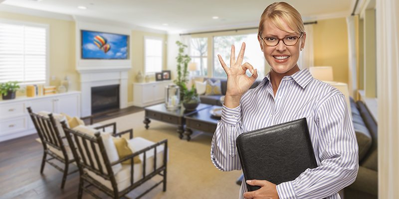 A female in a home tour doing OK sign.