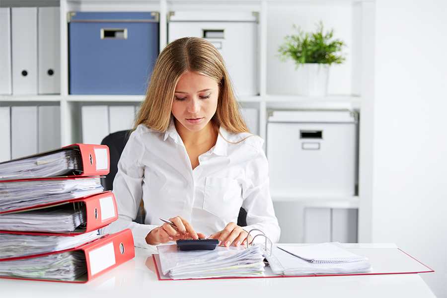 Young Woman Doing Payroll in her office.