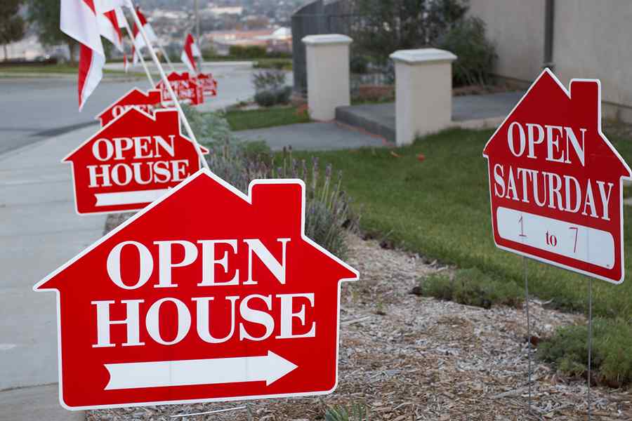 Showing a number of open house sign boards.