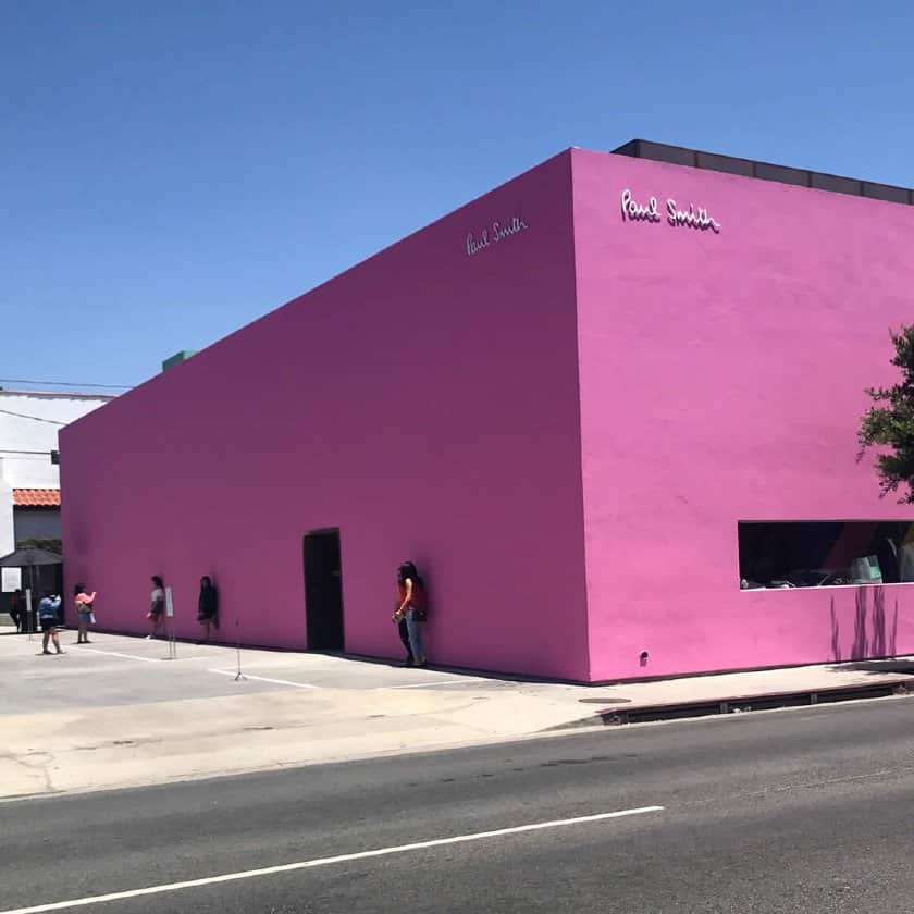 Tourists pose at the iconic pink wall for a photo op.