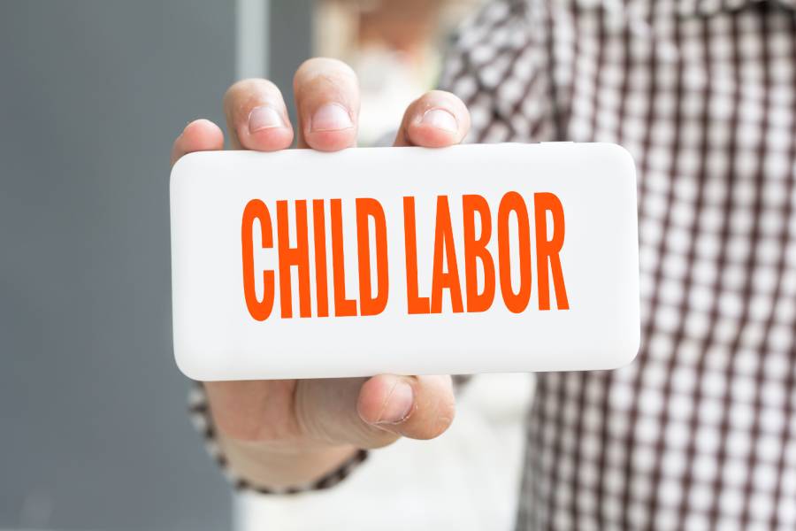 Holding a child labor sign.