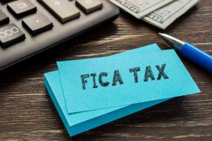 FICA tax written on a paper.