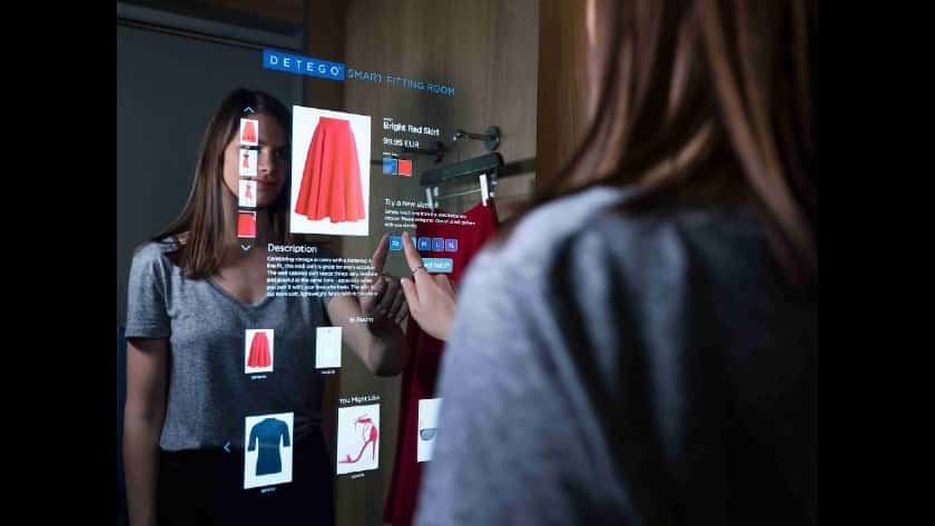 A woman using a smart mirror.