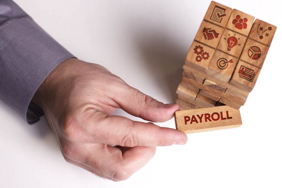 Businessman shows the word: Payroll.
