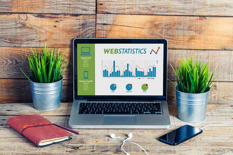 Laptop displaying website with business website statistics.