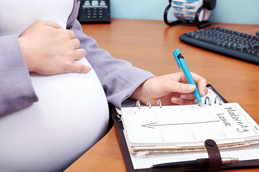 Pregnant woman writing. on a Notebook
