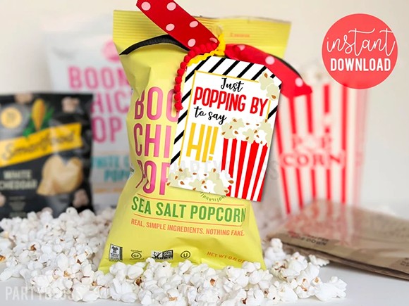 Bag of store bought popcorn with tag that says, "Just popping by to say hi!"