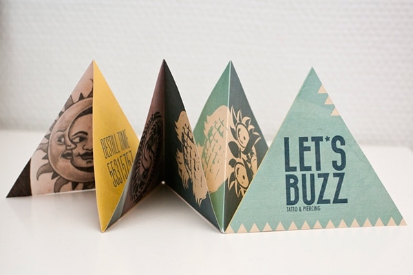 Triangle-shaped brochures for a tattoo parlor.