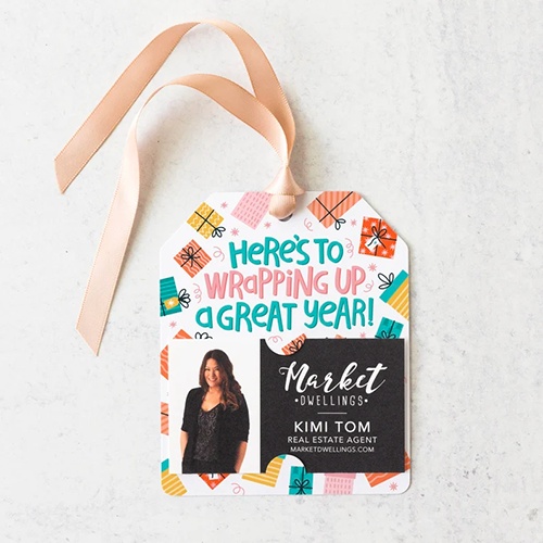 Gift tag with business card that says, "Here's to wrapping up a great year!"