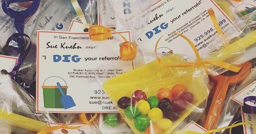 Plastic sand toys wrapped with gift tag that says, "I dig your referrals!"