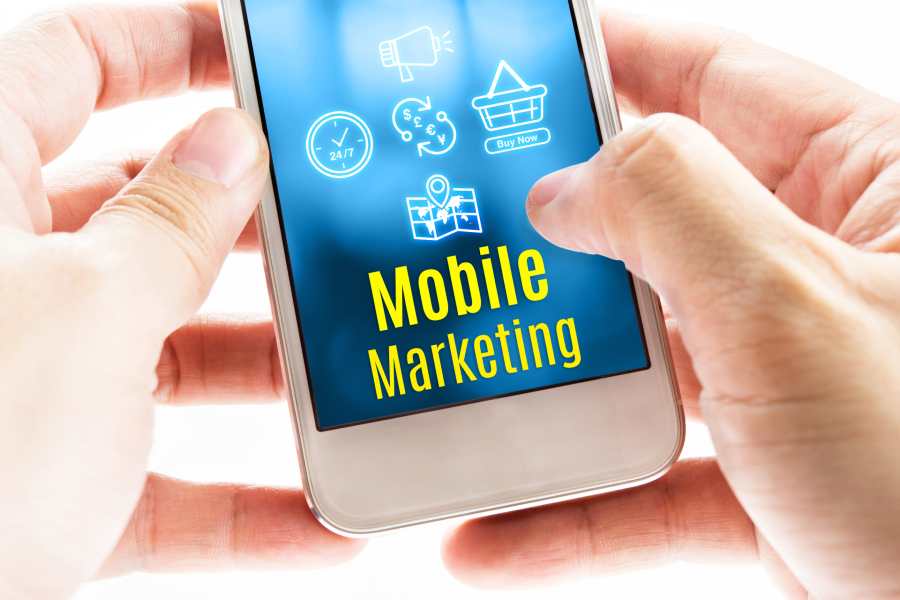 Holding A Smartphone With Mobile Marketing on Screen