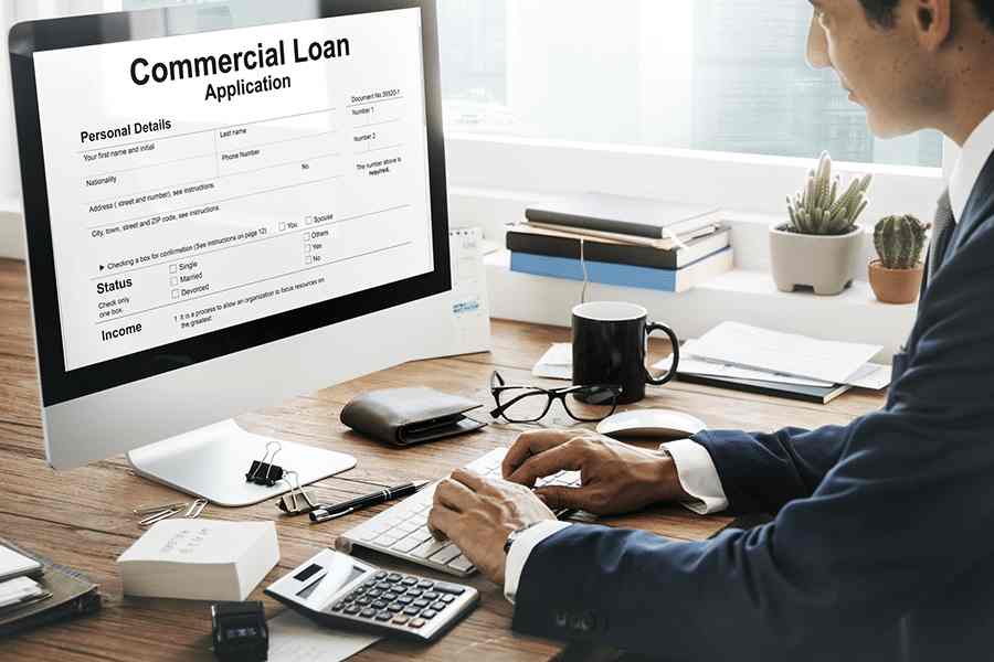 man filling up commercial loan application
