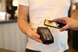 erson making payment via terminal and mobile phone
